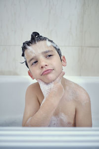 Brothers bathing and playing with foam