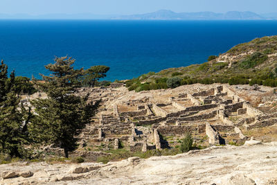 Scenic view of sea and mountains against sky