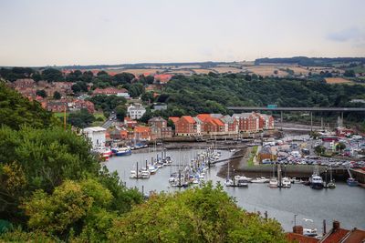 High angle view of river by townscape against sky