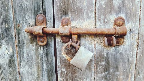 Close-up of padlock on rusty door