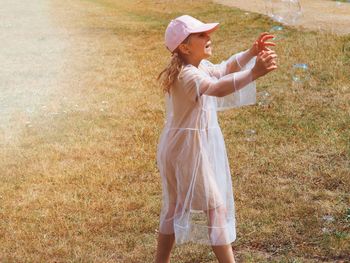 Side view of woman standing in field