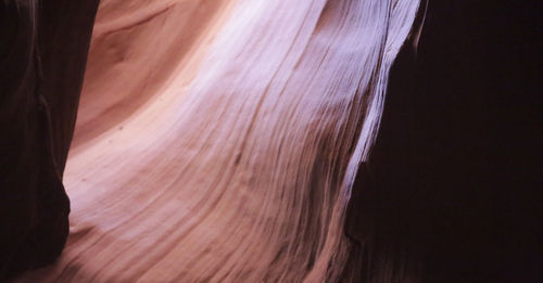 Close-up of woman against black background