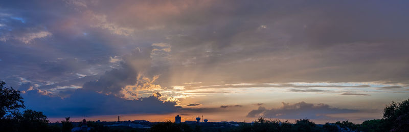 Panoramic view of city against sky at sunset