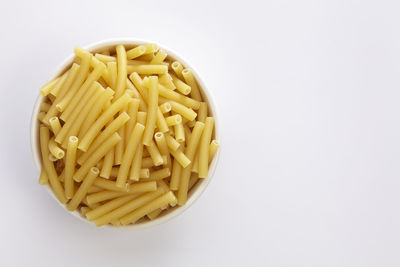 Close-up of pasta in bowl against white background