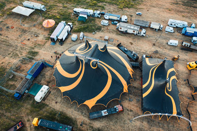 The yellow and black circus tent with animals and jugglers