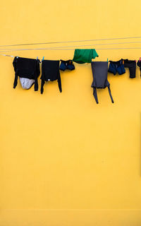 High angle view of clothes drying against yellow wall