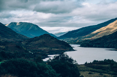 Scenic view of lake and mountains against sky