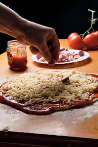 Preparing pizza base at home, we put tomato, cheese,...