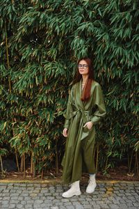 Young woman standing amidst plants