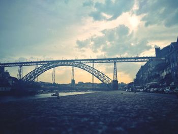 View of bridge over river against cloudy sky