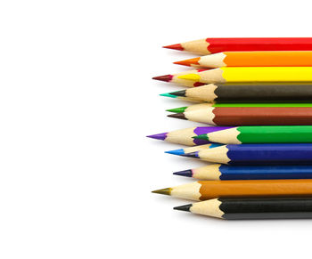 Close-up of colored pencils against white background
