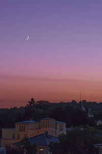 Silhouette buildings against sky at sunset