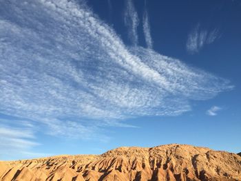 Scenic view of arid landscape against sky