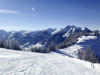 Scenic view of snow covered mountains against sky