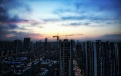 Skyscrapers in city at sunset