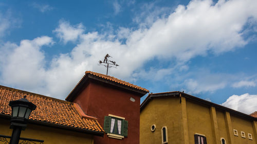 Low angle view of building against cloudy sky