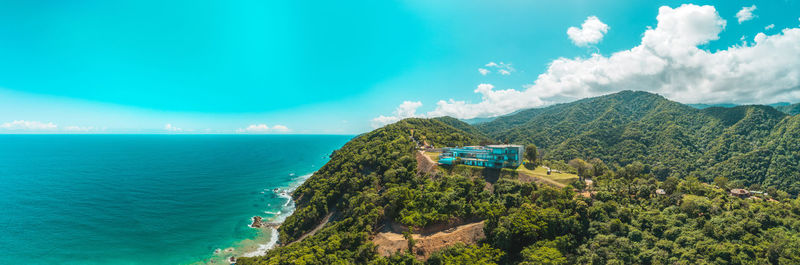 Aerial view the luxurious villa with pool on the edge of the mountain on the ocean coast