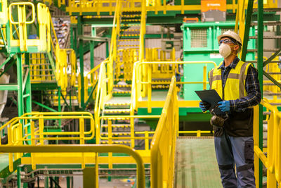 Portrait of young woman standing in factory