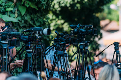 Cameras at a media conference outdoors.