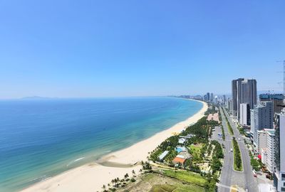 Scenic view of beach against clear blue sky