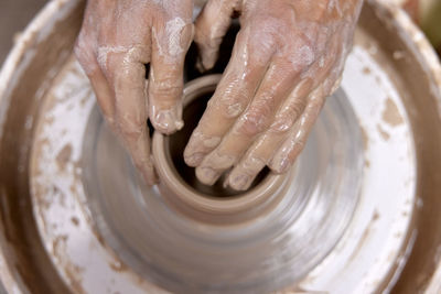 Cropped image of man making pottery