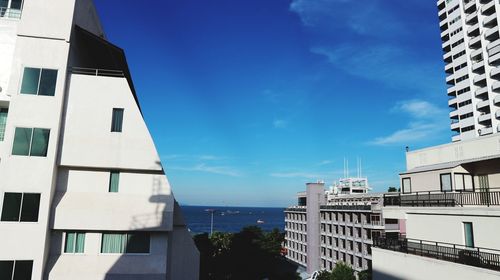 Low angle view of buildings in town against sky