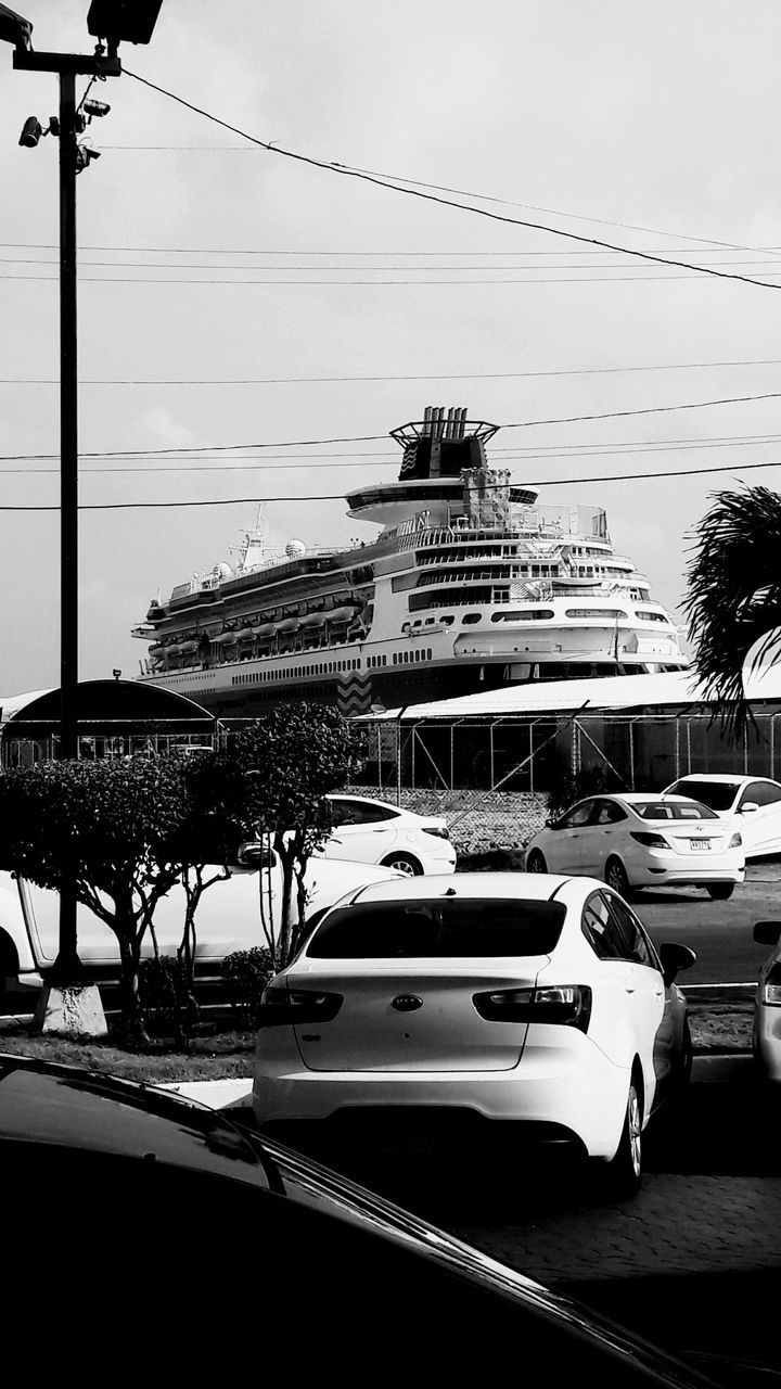 bird, transportation, mode of transport, nautical vessel, clear sky, moored, animal themes, building exterior, in a row, animals in the wild, built structure, harbor, architecture, wildlife, sky, flying, boat, outdoors, day