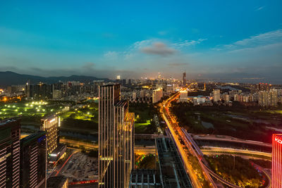 High angle view of illuminated city buildings at night