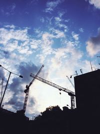 Low angle view of crane against sky
