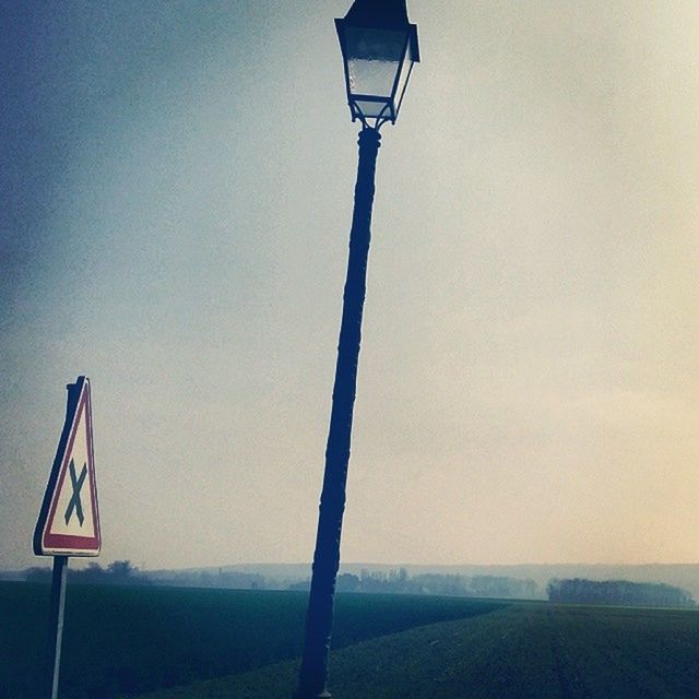 clear sky, street light, pole, tranquility, lighting equipment, tranquil scene, sky, copy space, nature, scenics, no people, outdoors, beauty in nature, landscape, hanging, electricity, day, low angle view, guidance, horizon over water