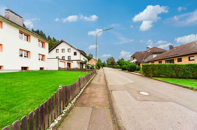 Street amidst buildings against sky