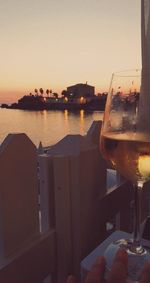 Close-up of glass of boat at sunset