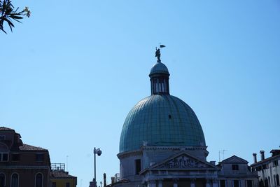 View of buildings against clear blue sky