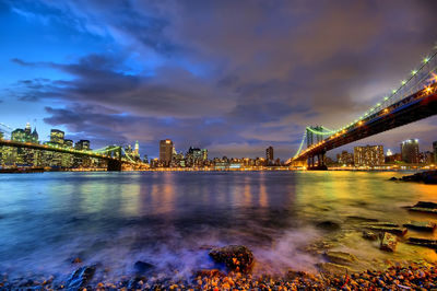 International bridges over river against cityscape at night