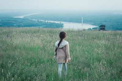 Rear view of girl looking at field