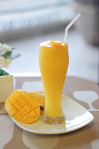 Close-up of orange juice on table