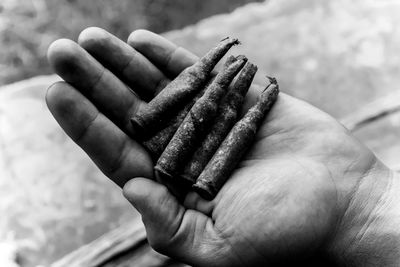 Close-up of man holding bullet shells