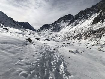 Scenic view of snow covered mountains against sky