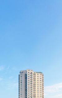 Low angle view of buildings against clear blue sky