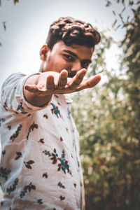 Low angle portrait of man holding outdoors