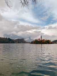 Scenic view of lake by buildings against sky