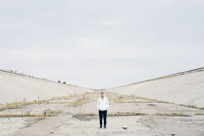 Rear view of man walking on desert