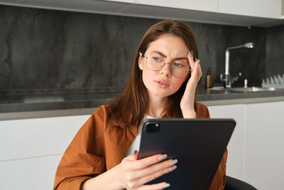 Young woman using digital tablet