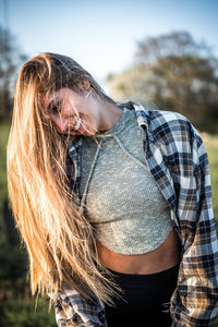 Midsection of woman looking at camera