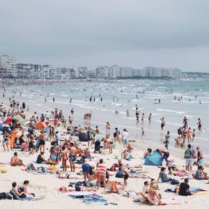 High angle view of people at beach against sky