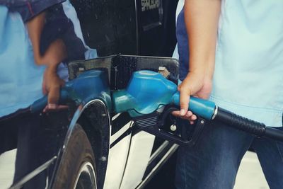 Midsection of man holding car