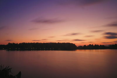 Scenic view of lake against romantic sky at sunset