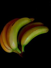 Close-up of green chili pepper over black background