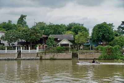 Scenic view of lake and building against sky