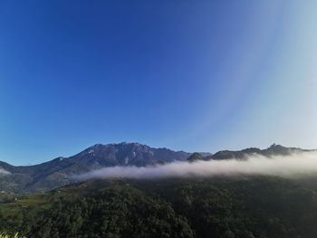 Scenic view of mountains against clear blue sky